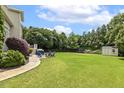 Spacious backyard perfect for outdoor activities with ample green space and seating area at 5516 Colonial Oaks Dr, Apex, NC 27539