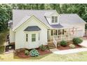 Charming home with well-kept lawn, covered porch, and landscaping, offering a cozy curb appeal at 589 John Mitchell Rd, Youngsville, NC 27596