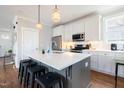 Modern kitchen boasts a spacious island, stainless steel appliances, and elegant pendant lighting at 595 E Cabarrus St, Raleigh, NC 27601
