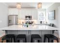 Stylish kitchen with a large island, counter seating, modern appliances, and decorative pendant lights at 595 E Cabarrus St, Raleigh, NC 27601