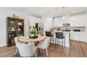Modern kitchen featuring stainless steel appliances, white cabinetry, and a cozy breakfast bar with seating at 611 Callan View Ave, Wake Forest, NC 27587