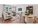 Open-concept living and dining area with modern furniture and natural light, ideal for entertaining at 611 Callan View Ave, Wake Forest, NC 27587