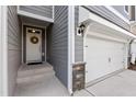 Inviting entryway with a classic door, brick accents, and an attached garage at 629 Newlyn Dr, Raleigh, NC 27606