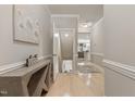 Hallway with light wood flooring, neutral paint, and an open view to the kitchen at 629 Newlyn Dr, Raleigh, NC 27606