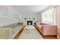 Inviting living room with fireplace, hardwood floors, and neutral paint scheme at 808 Ravenwood Dr, Raleigh, NC 27606