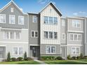 New construction townhome with modern farmhouse facade, landscaped front yard, and stone accents at 809 Hyperion Aly, Wake Forest, NC 27587