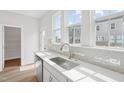 Contemporary kitchen with stainless steel sink, dishwasher, and white countertops at 809 Hyperion Aly, Wake Forest, NC 27587