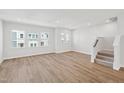 Spacious living room with hardwood floors and plenty of natural light from large windows at 809 Hyperion Aly, Wake Forest, NC 27587