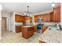 Eat-in kitchen with stainless steel appliances, an island, and granite countertops at 9308 Carisbrook Ct, Raleigh, NC 27615