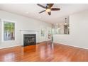 Bright living room with a fireplace, hardwood floors, and access to the backyard at 9308 Carisbrook Ct, Raleigh, NC 27615