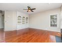 Spacious living room with hardwood floors and custom built-in shelving at 9308 Carisbrook Ct, Raleigh, NC 27615