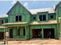 New construction home in progress features Zip System sheathing, framed openings for windows and garage at 1011 Coldspring Circle, Durham, NC 27705