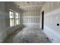 Unfinished bedroom featuring two windows offering great light and potential for customization at 1027 Coldspring Circle, Durham, NC 27705