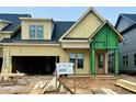 New construction featuring wood framing, zip system sheathing, and a light yellow exterior at 1027 Coldspring Circle, Durham, NC 27705