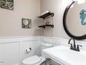 Cozy half-bathroom features a unique round mirror and stylish coastal decor at 1100 Open Field Dr, Garner, NC 27529