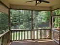 Screened back porch offering a serene view of the lush, wooded backyard at 112 Briarfield Dr, Apex, NC 27502