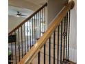 View of staircase with wooden handrail, iron spindles, and carpeted steps, leading to an upstairs living space at 112 Briarfield Dr, Apex, NC 27502