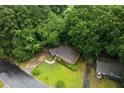 Aerial view of home with mature trees, driveway, and lush surrounding landscape at 1219 Lakeland St, Durham, NC 27701