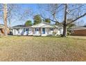 Charming one-story home with a well-manicured lawn and a welcoming front porch with stylish wooden pillars at 1246 Nc-27, Benson, NC 27504