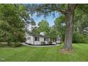 Attractive white brick home with manicured lawn and trees providing natural shade and curb appeal at 132 Edgewood Dr, Louisburg, NC 27549