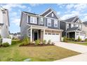 Beautiful new construction home with lush green lawn and a two-car garage at 1725 Winter Jasmine Ln, Wake Forest, NC 27587
