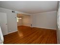 Bright living room featuring hardwood floors, light gray walls, and an open layout at 1908 Smallwood Dr, Raleigh, NC 27605