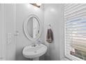 Powder room with pedestal sink and a view from a window at 224 Swann Trl, Clayton, NC 27527