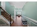 Inviting hallway with hardwood floors, decorative trim, and an airy, open feel at 224 Swann Trl, Clayton, NC 27527