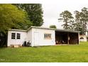 Outbuilding featuring white siding with green grass surrounding at 250 Patterson Dr, Roxboro, NC 27573