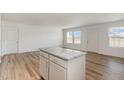 Open kitchen view with a large granite island and plenty of natural light at 261 Johnson Ridge Way, Four Oaks, NC 27524