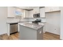 Bright kitchen featuring stainless steel appliances, granite countertops, and a center island at 261 Johnson Ridge Way, Four Oaks, NC 27524