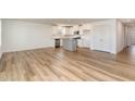 Open-concept living room and kitchen area with hardwood flooring and modern finishes at 261 Johnson Ridge Way, Four Oaks, NC 27524