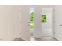 Bright entryway featuring a modern door and wood-look floors, leading into a carpeted living space at 284 Johnson Ridge Way, Four Oaks, NC 27524