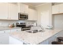 Bright kitchen featuring granite countertops, stainless steel appliances, and ample storage at 296 Johnson Ridge Way, Four Oaks, NC 27524