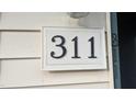 Close up of the address number '311' on a condo building, indicating the unit number within the complex at 311 Ashley Forest Rd # Bldg E, Chapel Hill, NC 27514