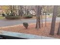 View from condo balcony of a neighborhood street in the fall with leaves on the ground and other buildings in the distance at 311 Ashley Forest Rd # Bldg E, Chapel Hill, NC 27514