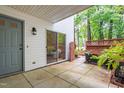 Private patio area featuring a sliding glass door and a tranquil outdoor space at 320 Summerwalk Cir, Chapel Hill, NC 27517