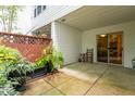Relaxing covered patio with tiled flooring and cozy seating area overlooking a fenced-in area at 320 Summerwalk Cir, Chapel Hill, NC 27517