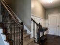 Welcoming foyer featuring a staircase with decorative iron railings and stylish wainscoting at 33 Northlodge Ct, Wendell, NC 27591