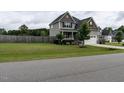 Attractive home with a well-manicured lawn, a two-car garage and complemented by a wooden perimeter fence at 33 Northlodge Ct, Wendell, NC 27591