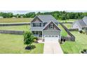 Beautiful two-story home with a well-manicured lawn, attached garage and a fenced backyard at 33 Northlodge Ct, Wendell, NC 27591