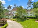 Beautiful two-story white brick home with a circular driveway and manicured front lawn at 3307 Devon Rd, Durham, NC 27707