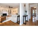 Bright and airy living room featuring hardwood floors and a white painted brick fireplace at 3317 E Jameson Rd, Raleigh, NC 27604