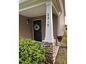 Covered front porch with brick pillar and a decorative wreath at 3515 Mountain Brook Cir, Durham, NC 27704