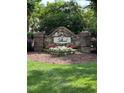 Landscaped entrance to Stillwood, featuring a stone sign and colorful flowerbed at 3515 Mountain Brook Cir, Durham, NC 27704
