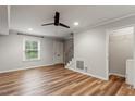 Living room showcasing wood floors, modern fan, and closet with laundry hookups at 3720 Jamestown Cir, Raleigh, NC 27609