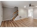 The living room offers a modern ceiling fan, staircase, and hardwood floors at 3720 Jamestown Cir, Raleigh, NC 27609