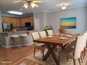 Dining room features a wooden table, seating for six, and open view into the kitchen with barstool seating at 4202 Cherry Blossom Cir, Durham, NC 27713