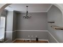 Elegant dining room featuring archways, crown molding, floating shelves, and a modern chandelier at 4202 Cherry Blossom Cir, Durham, NC 27713