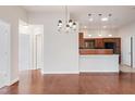 Open concept dining area featuring hardwood floors and a decorative chandelier at 425 Faith Dr, Gibsonville, NC 27249